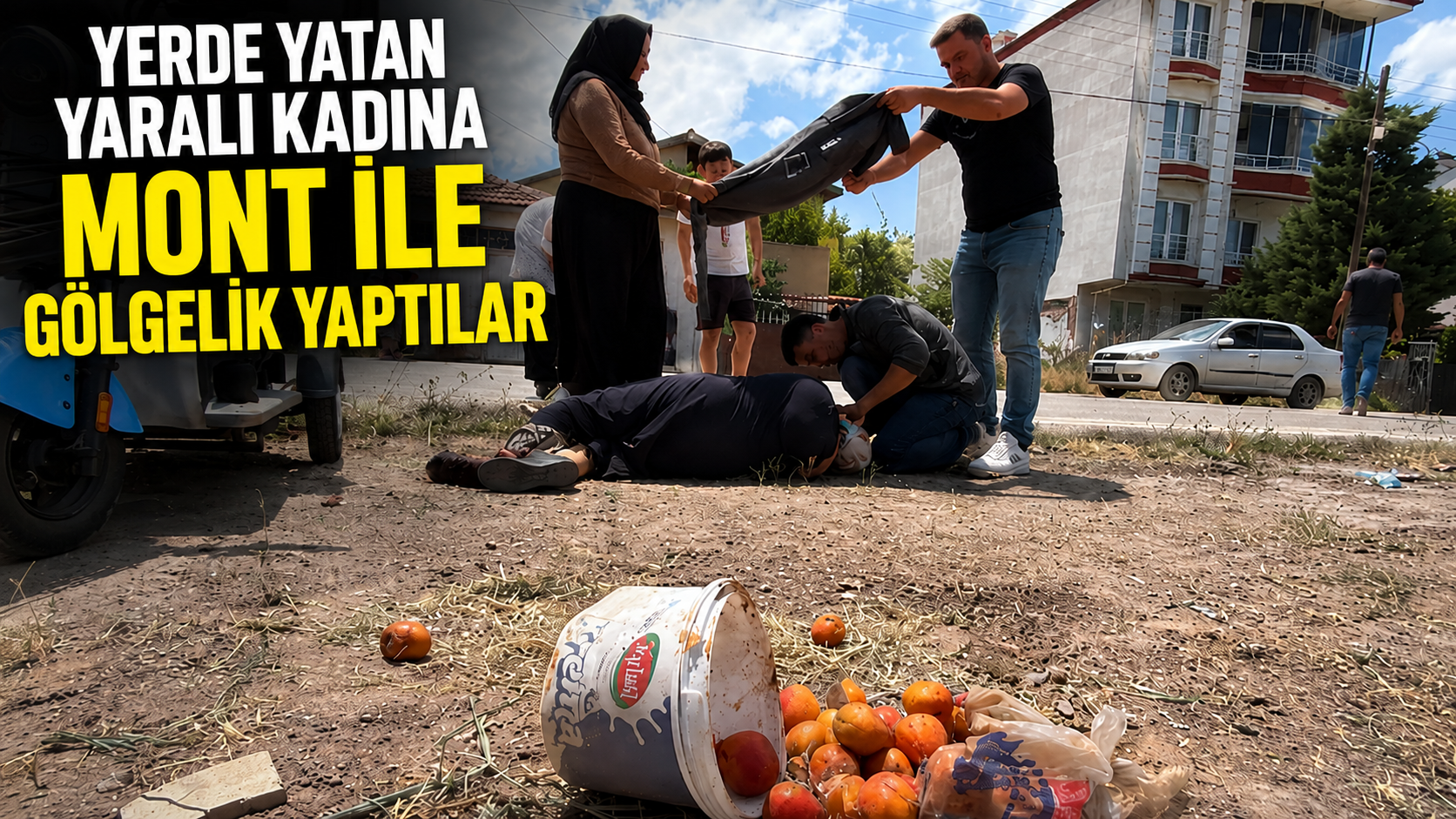 Yerde yatan yaralı kadına mont ile gölgelik yaptılar